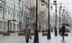 Citizens walk along Nikolskaya Street in the city’s centre