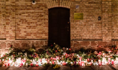 Candles and flowers are laid in front of the synagogue in Halle after the attack last year