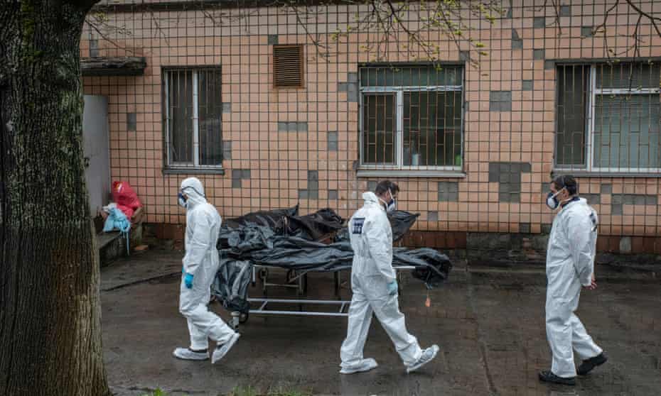 Forensic experts with bodies of civilians killed in Bucha
