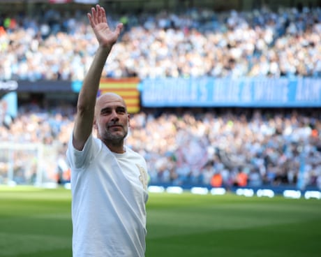 Pep Guardiola waves to fans before the match