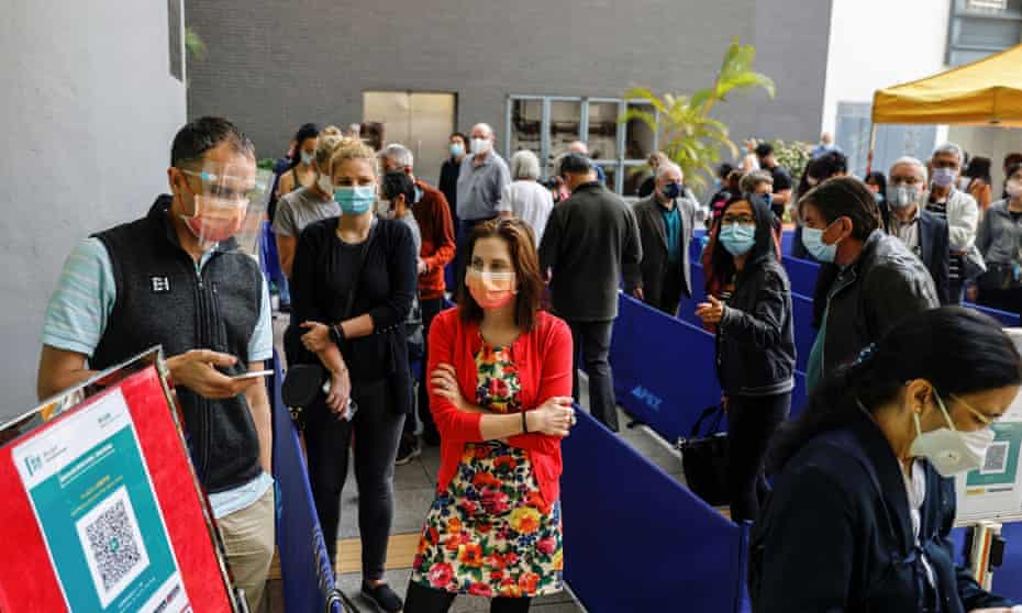 People queue up at a vaccination centre after Hong Kong suspended use of the Pfizer coronavirus vaccine.