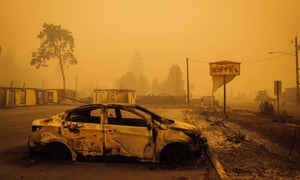 A charred vehicle is seen in the parking lot of the burned Oak Park Motel after the passage of the Santiam Fire in Gates, Oregon.