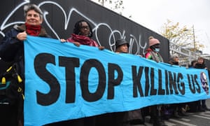 Members of climate action protest group Scientist Rebellion hold a banner during a demonstration in Glasgow