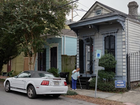 Darlene Jones sweeps the sidewalk in front of her home in the Treme neighborhood of New Orleans, Louisiana, on 12 November 2023.