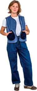 A young woman with a dark blond bob, wearing a blue cord waistcoat with large navy patch pockets over a white T-shirt and jeans