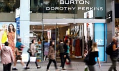 People walk past a Burton and Dorothy Perkins store in London