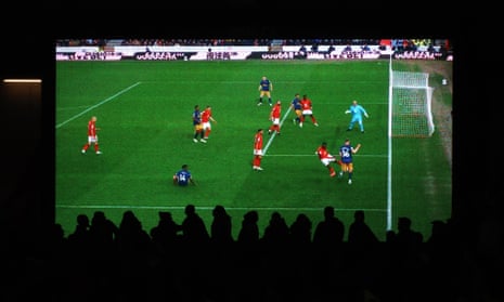 Fans watch replays on the big screen as Newcastle United's Elliot Anderson scores a disallowed goal after a VAR review.
