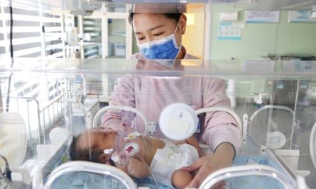 A medical worker takes care of a newborn baby at a hospital in Zhejiang province, China.