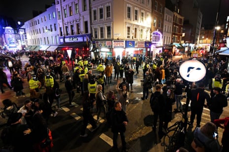 Police disperse people on Old Compton street in Soho at the 10pm curfew on 16 October, the night new tier 2 lockdown restrictions came into force in London.