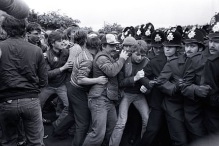 Pickets and police pushing up against each other.