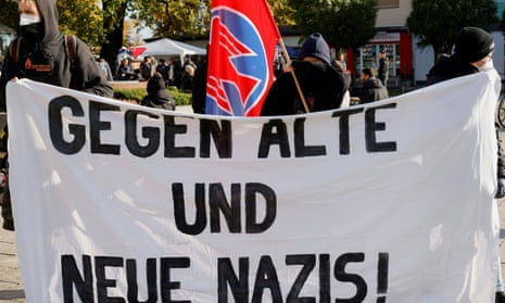 Protesters hold a banner reading ‘Against old and new Nazis!’ during a  vigil  in Guben