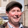 John Gardner standing next to his stall