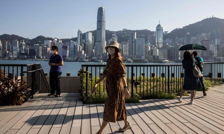 people are seen at the West Kowloon Cultural district overlooking Victoria Harbour in Hong Kong 