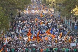Protesters wave Catalan independence flags as they demonstrate against the Spanish federal government’s move to suspend Catalonian autonomy