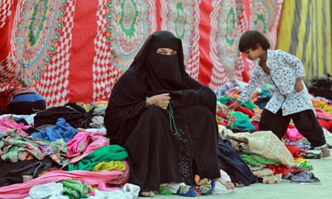 A Muslim woman holds prayer beads inside a camp in Mustafabad, a makeshift relief camp north-east of Delhi.