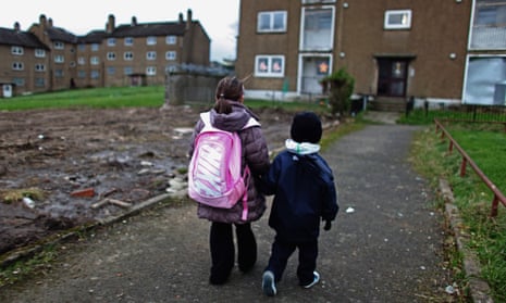 Two children make their way back home in Glasgow, Scotland