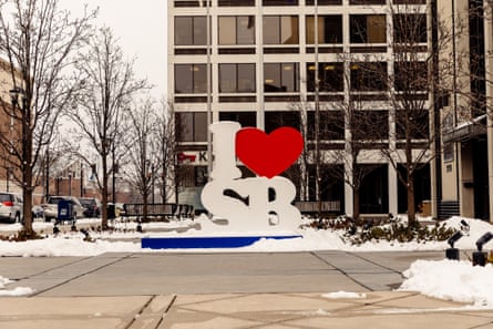 A city pride sculpture on Michigan Street, a busy row of shops and office buildings in downtown South Bend.
