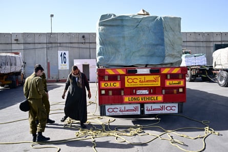 Israeli security forces inspect humanitarian aid trucks arriving from Egypt before they cross into Gaza.