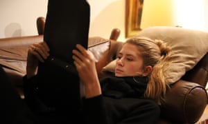 A woman lying on a sofa.