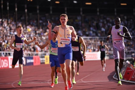Cooper Lutkenhaus holds up a finger while competing at a race.