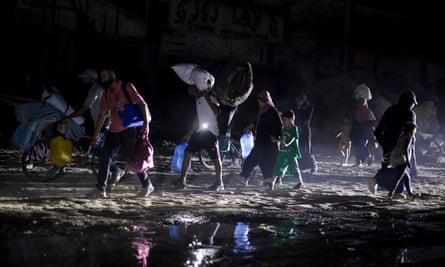 Palestinians displaced by the Israeli air and ground offensive on the Gaza Strip flee from parts of Khan Younis.