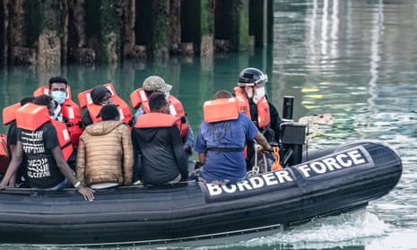 A Border Force dinghy escorts intercepted migrants into Dover.