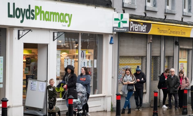 People queue outside Lloyds Pharmacy in Tranent,