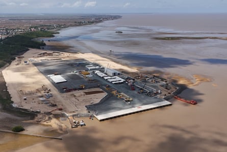 Seen from the air, port facilities to support offshore oil production under construction near the mouth of the Demerara River in Georgetown.