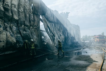Firefighters at a warehouse in the Kyiv region after a Russian attack