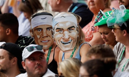 Spectators wear masks of Rafael Nadal and Roger Federer during the fourth round match between Carlos Alcaraz and Matteo Berrettini