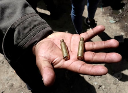 A man shows cartridge cases after clashes in El Alto on the outskirts of La Paz.