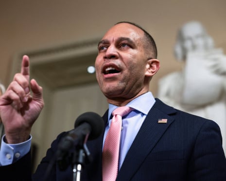 Man speaks into microphone and raises finger