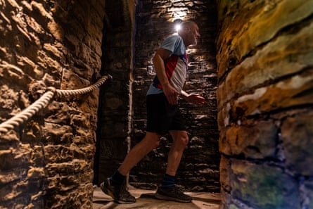 Man running through stone tunnel