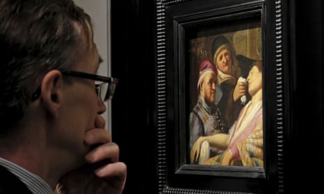 A visitor to the TEFAF art fair looks at a newly discovered painting by Dutch master Rembrandt