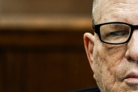 A closeup of half of his face. He is wearing glasses and a stern expression