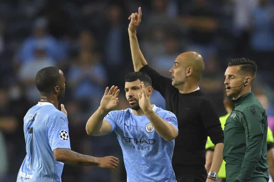 Manchester City’s head coach Pep Guardiola points to his players as Sergio Aguero comes on.