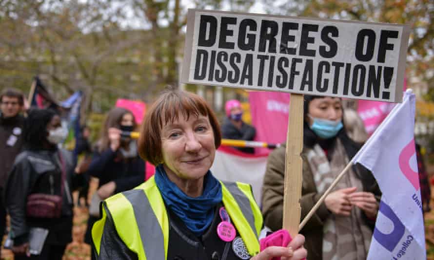 A woman on a UCU march holding up a placard that says ‘Degrees of dissatisfaction’