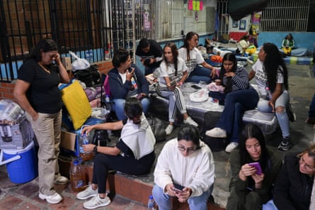 Family members of detainees prepare to sleep outside the El Rodeo jail