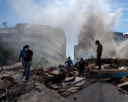 Rescuers and volunteers search for survivors in La Guaira, Venezuela.