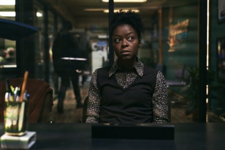 Danielle Deadwyler sitting at a desk looking anxious in Station Eleven.