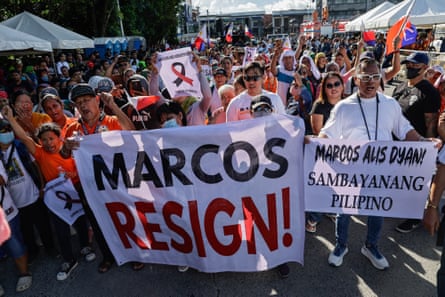 Protesters hold signs calling for the resignation of Philippine president Ferdinand Marcos Jr, during an anti-corruption rally.