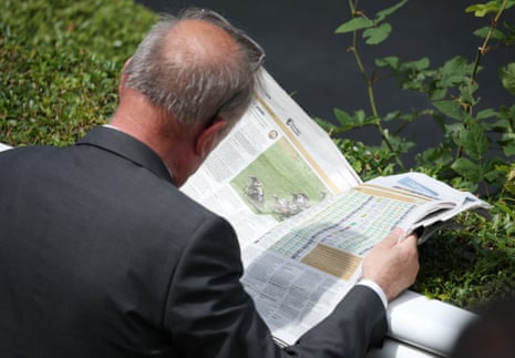 A racegoer studying the form at Royal Ascot.