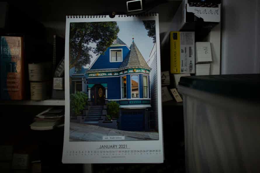 A calendar with a picture of a blue Victorian house.