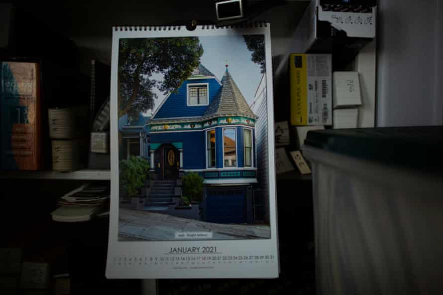 A calendar with an image of a blue Victorian home.