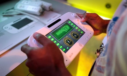 An attendee plays a video game using Nintendo’s Wii U controller at E3 2012 in Los Angeles, 5 June 2012.