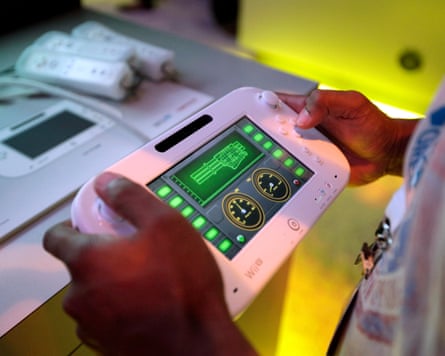 An attendee plays a video game using Nintendo’s Wii U controller at E3 2012 in Los Angeles, Tuesday, June 5, 2012. Nintendo unleashed 23 games for its upcoming console featuring a touchscreen controller at the Electronic Entertainment Expo, or E3, the gaming industry’s annual trade show. (AP Photo/Jae C. Hong)