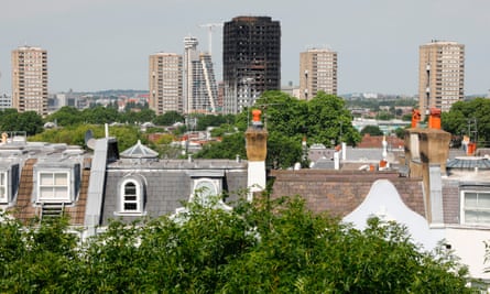 Signs of social division … Grenfell Tower block is seen behind town houses in affluent Notting Hill, west London.
