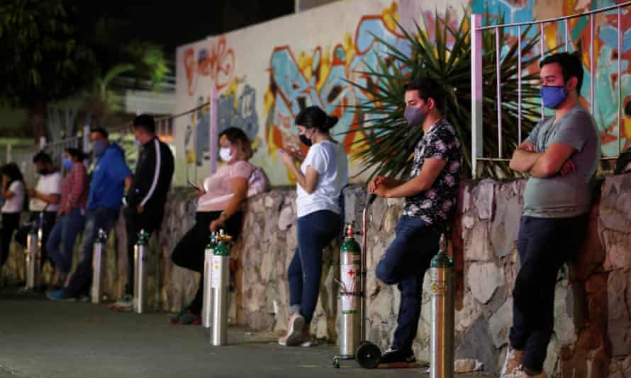 Members of the Oxygen on Wheels non-profit group prepare to attend Covid-19 patients by bringing them oxygen tanks at home, in Guadalajara, Mexico.