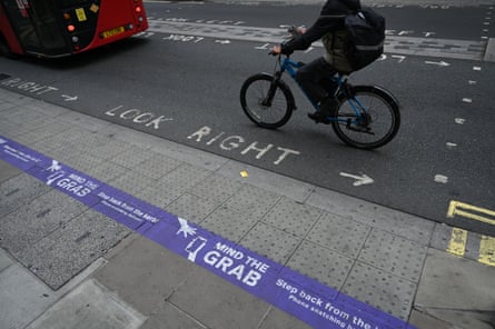 A sign painted on the road that reads ‘mind the grab’