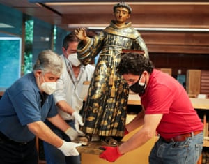 Workers at Mexico’s National Museum of Anthropology move a sculpture of Saint Anthony of Padua